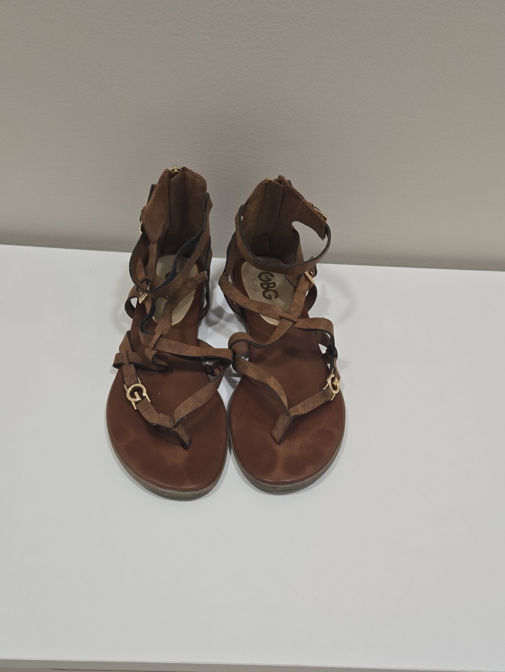 G by Guess Brown Strappy Gladiator Sandals with Gold Accent